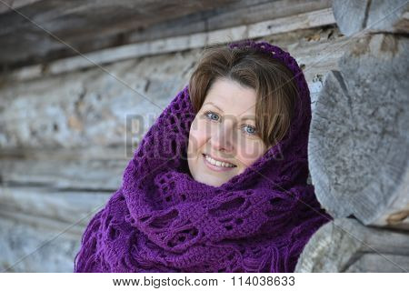 The Russian Woman In  Shawl Warms Hands Near An Izba