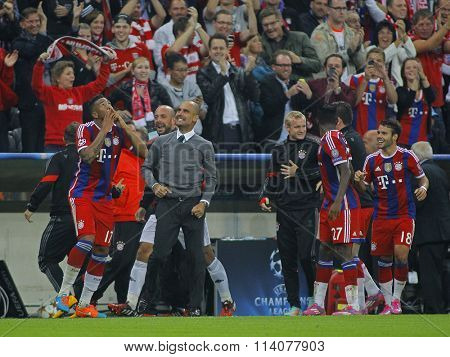 MUNICH, GERMANY - SEPTEMBER 17 2014:  Pep Guardiola celebrates with players during the UEFA Champions League match between Bayern Munich and Manchester City, at the Allianz Arena, Munich, Germany. 