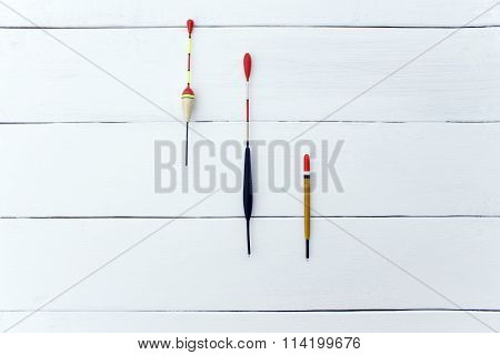 Various floats on a wooden surface