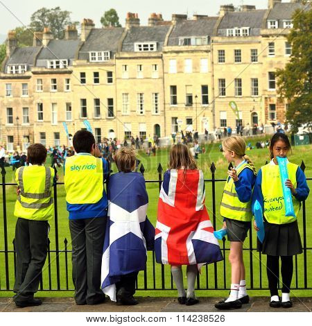 Children in flags watching Tour of Britain