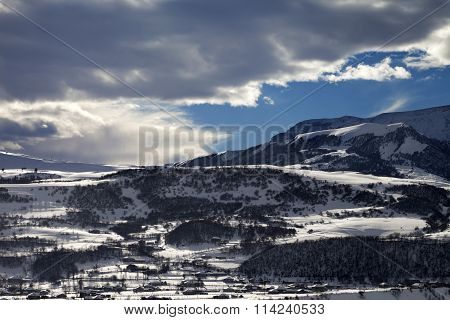 Winter Mountains And Village At Evening