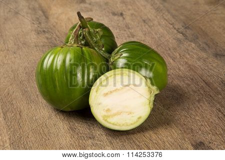 Some Green African Eggplants Over A Wooden Surface