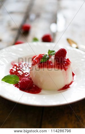 Delicious Italian Dessert Panna Cotta With Raspberry Sauce And Mint On White Background