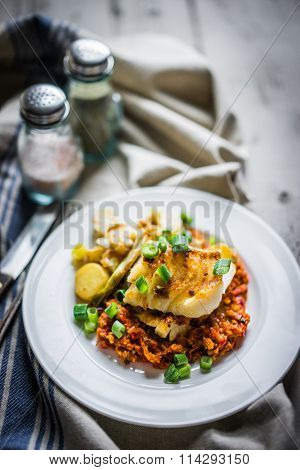 Roasted Hake With Romesco Sauce And Onion On Wooden Background