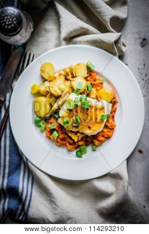 Roasted Hake With Romesco Sauce And Onion On Wooden Background