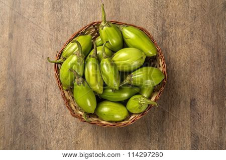 Some Green African Eggplants Over A Wooden Surface