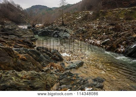 River With Green Waters, Snow And Ice Near Xanthi In Greece