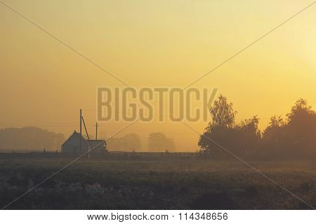 beautiful sun illuminates House in the mist