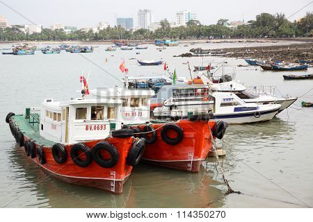 VUNG TAU, VIETNAM - December 16, 2015: Old fishing boats in the port of Vung Tau