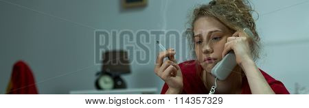 Depressed Woman Listening To Voicemail