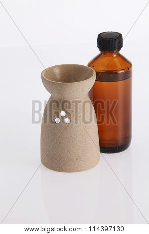 aromatheraphy oil with burner on the white background