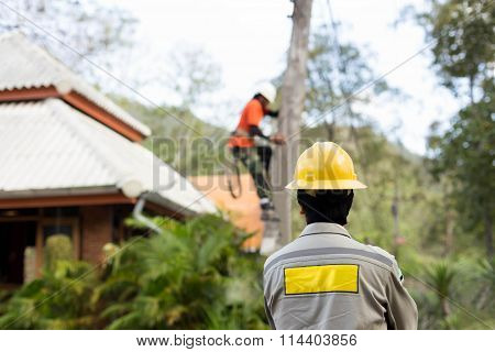 Electrician lineman working on electric post power pole