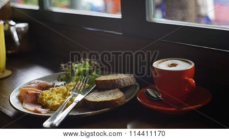 Breakfast Meal With A Cup Of Cappuccino In The Soft Light Mood With A Little Blurry