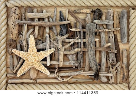 Driftwood and starfish abstract background over oak wood with rope surround.