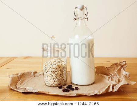 real comfort wooden kitchen with breakfast ingredients close up in glass, honey, oatmeal, milk, mues