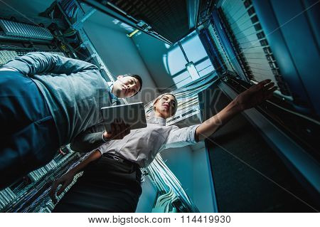 Young engineers businessmen in server room