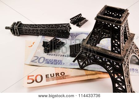 Broken Eiffel tower on money