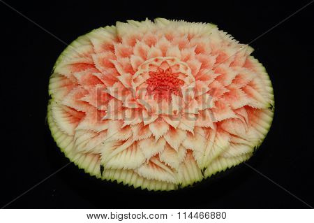 watermelon carving display on black background