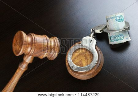 Judges Gavel, Handcuffs And  Russian Cash  On The Black Table