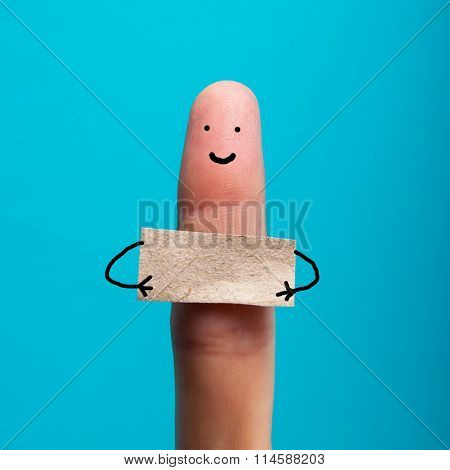 Funny finger holding blank bunner showing on it and smiling
