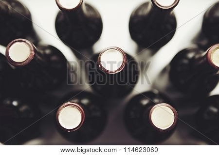 Glass bottles of wine on white background, close up