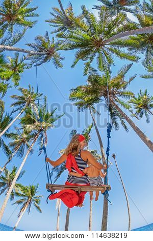 Mother With Baby Girl Fly High In Sky On Swing