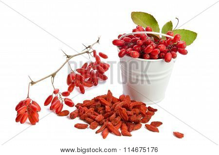 Metal Bucket With Berberries Near Heap Of Goji Berries  Isolated On White Background