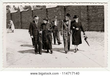 Vintage photo shows a group of people during a walk