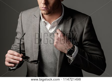 Confident sharp dressed man in grey suit 