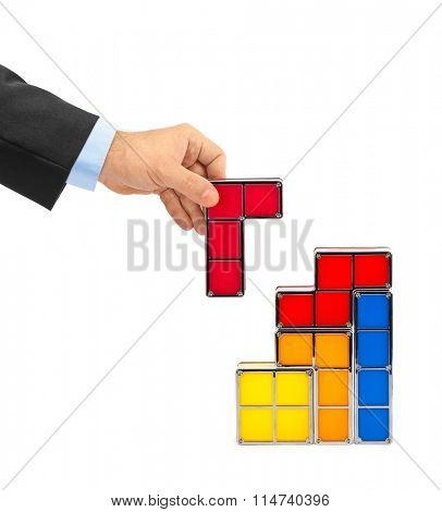 Hand with tetris toy blocks isolated on white background