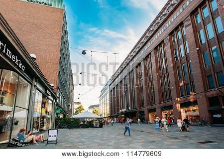 View of Kluuvikatu street, HELSINKI, FINLAND. People walk down street on a summer evening.