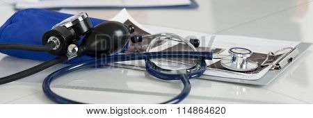 Medical Manometer And Stethoscope Laying On Medicine Doctor's Working Table