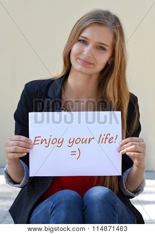 Beautiful, cheerful, smiling, light-haired girl with an inscription 