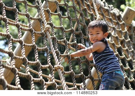 Japanese boy playing with rope ladder (3 years old)