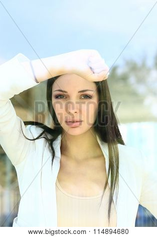 business woman looking thtough window in the office