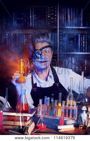 Portrait of a crazy medieval scientist working in his laboratory. Alchemist. Halloween.