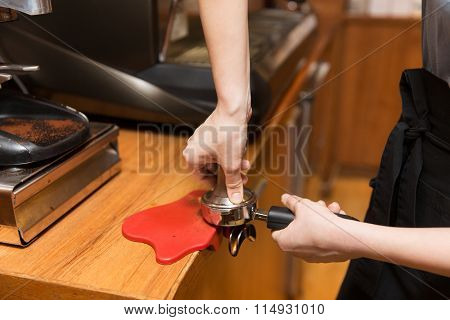 close up of woman making coffee by machine at cafe