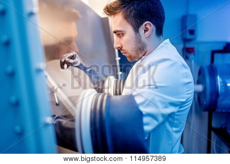 Scientist Using Protective Robber Gloves For Handling Dangerous Substances In Sterile Environment