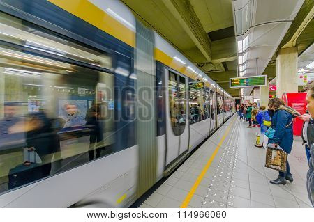 BRUSSELS, BELGIUM - 11 AUGUST, 2015: Inside Beurs station on passenger platform showing grey train a