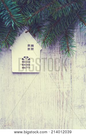 Christmas background. Christmas trees and Christmas decorations are on old light boards. Fir branches. Handmade decorations. Toned image. Space for text.