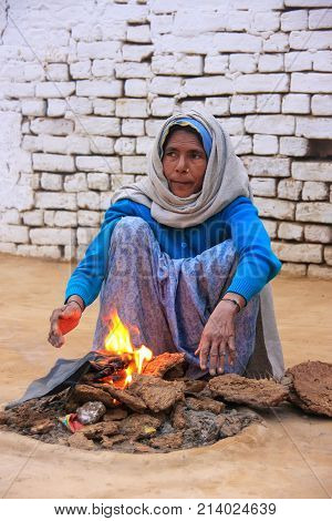 Agra, India-january 30: Unidentified Woman Makes Fire Using Dry Cow Dung In Taj Ganj Neighborhood On