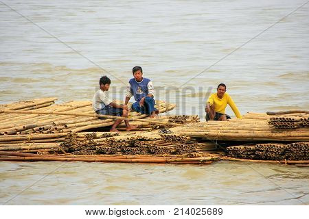 Mandalay, Myanmar - December 30: Unidentified Men Float On A Bamboo Raft Down Ayeyarwady River On De
