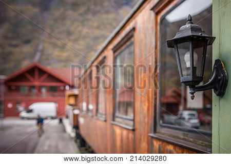 Old metal lamp on the side of the old Flamsbana train carriage in the railway museum in the Flam town, Norway