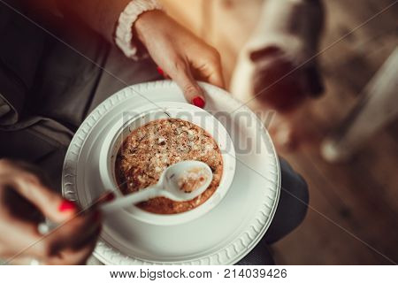 Woman hands holding white plastic plate with homemade tomato soup