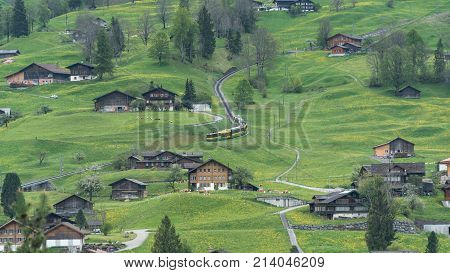 Switzerland - May 2017: Alpine express rushing through scenic valley in Switzerland
