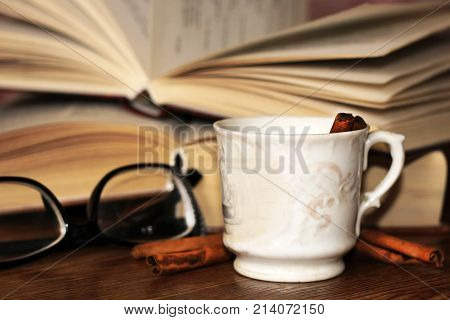 A Cup Of Coffee, Cinnamon Sticks And Old Books
