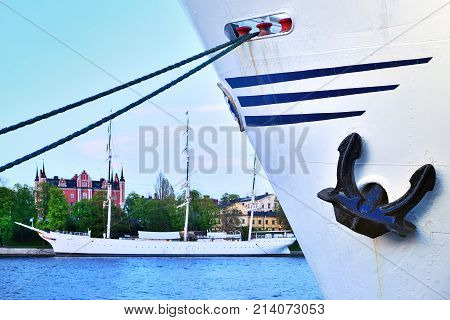 Ship With Ankor Against Water And Sailing Ship