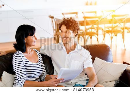 Couple with papers in their living room