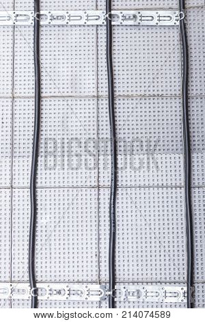 Electric floor heating system installation in new house electric heating cable is installed on the reinforcement grid with the help of mounting tape on the plates of expanded polystyrene