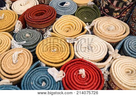 Variety of colorful Persian and Indian carpets on oriental bazaar
